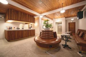 a living room with a couch and a table at Urban Pod Capsule Hostel in Bangkok