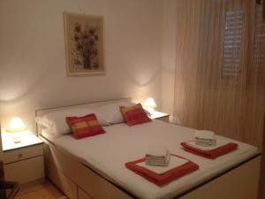 a bedroom with a bed with two towels on it at Apartment MeliRa in Novi Vinodolski