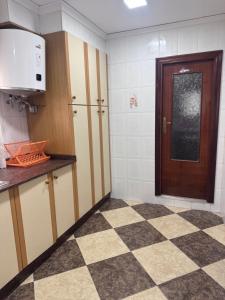 a kitchen with a door and a checkered floor at Casa en Manuel in Manuel