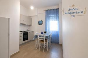 a kitchen with a table with a tablecloth on it at Donnaciccina Accomodation in Tropea