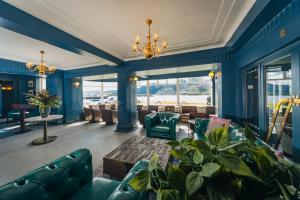a living room with blue walls and couches at The Lochalsh Hotel - Isle of Skye in Kyle of Lochalsh