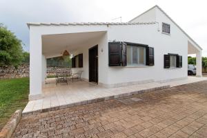 a white house with a patio in front of it at La Mansarda di Cecè in Ostuni