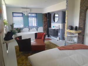 a living room with a table and a couch and a bathroom at Thorn BenB in Thorn
