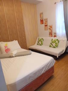 a room with two beds and a window at Lois Ann Condo in Pontud
