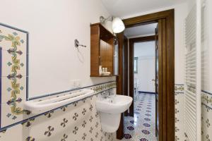 a bathroom with a sink and a toilet and a mirror at La Mansarda di Cecè in Ostuni +27 photos