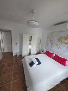 a bedroom with a large white bed with red pillows at Refugio Costa Teguise - Lanzarote in Costa Teguise