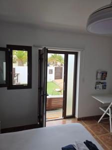 a bedroom with a door open to a patio at Refugio Costa Teguise - Lanzarote in Costa Teguise