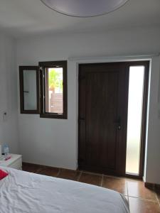 a bedroom with a bed and a door and a window at Refugio Costa Teguise - Lanzarote in Costa Teguise +28 photos