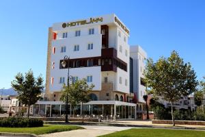 a tall white building with a sign on it at Hotel A44 in Tétouan