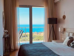 a bedroom with a large window with a view of the ocean at Altezza Premium Breathtaking Sea Views in Budva