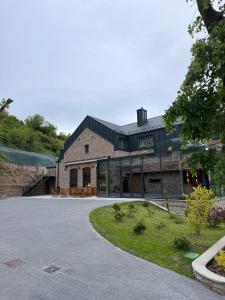 a large house with a driveway in front of it at Камінь in Ostrovets