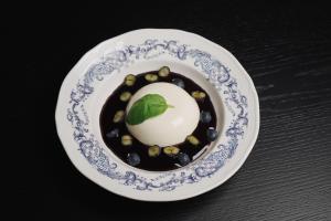 a plate of food with a dessert on a table at Камінь in Ostrovets