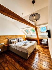 a bedroom with a bed in a room with skylights at Gospoda Dębowiec520 in Bielsko-Biała