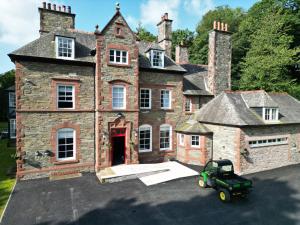 an old house with a tractor in front of it at Dunningwell Hall in Duddon +66 photos