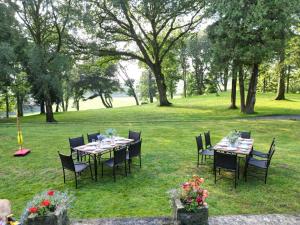 a table and chairs in a field with trees at Dunningwell Hall in Duddon