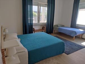 a bedroom with two beds and a window at Casa di Lucio in Lodi