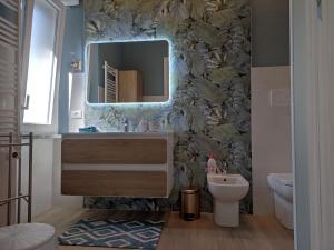 a bathroom with a sink and a mirror at Casa di Lucio in Lodi