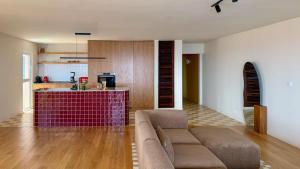 a living room with a couch and a kitchen at Horizon living Madeira in Caniço