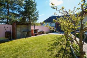 a backyard with a barbecue grill and a house at CHALUPA in Hosty