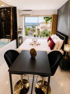a living room with a table and a large window at Luxury Beach Room in Frontignan