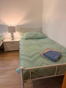 a bed with a green comforter in a bedroom at Green House in Neunkirchen +20 photos