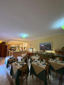 a restaurant with tables and chairs in a room at Residence Alberghiero Eolie in Lipari