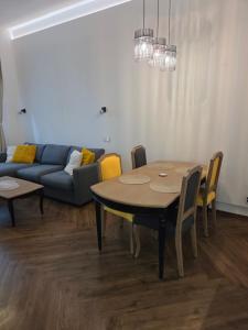 a living room with a table and a couch at Apartmán Square Lipno in Horní Planá