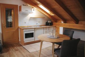 a kitchen with a table and a sink and a stove at Ferienwohnung Alpenwelt in Mittenwald