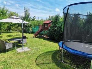 a playground with a slide and a table and an umbrella at Casa Corina in Turda