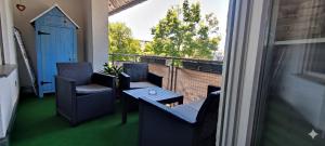 a balcony with chairs and a table and a window at Lake FeWo Santorini in Oberteuringen