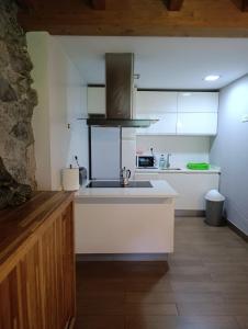 a kitchen with a sink and a counter top at Casa con encanto in Arredondo +38 photos