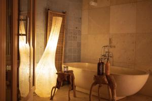 a bathroom with a bath tub and a shower at Oslo Guldsmeden in Oslo