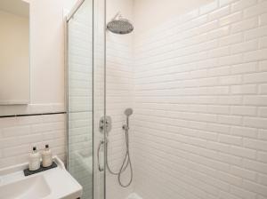 a white bathroom with a shower and a sink at Da nonno Carlo Lakeview - By BorgoLago in Capodimonte