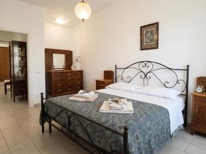a bedroom with a bed and a table with towels on it at Da nonno Carlo Lakeview - By BorgoLago in Capodimonte +7 photos