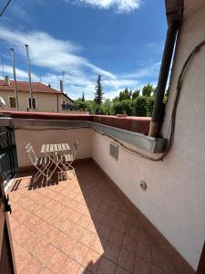 a balcony with two chairs on a roof at LB Guest House in Tagliacozzo