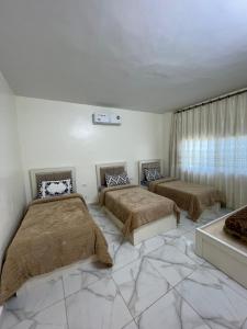 a bedroom with two beds and a window at Alreem Farm in Ajloun +13 photos