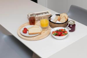 a table with a plate of bread and a bowl of strawberries at Sky Biescas II by BeValle in Biescas