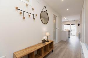 a hallway with a table and a mirror on the wall at Sky Biescas II by BeValle in Biescas +37 photos