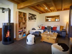 a living room with a couch and a fireplace at Chalet Aravista - OVO Network in Le Grand-Bornand +26 photos