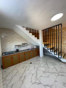 a kitchen with a staircase in a house at Alreem Farm in Ajloun