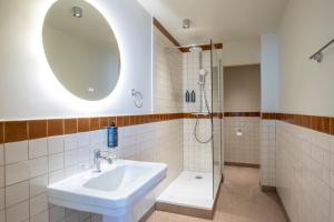 a bathroom with a sink and a shower at Best Western Hotel Centre Reims in Reims