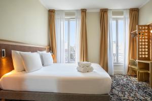 a hotel room with a bed with a teddy bear on it at Best Western Hotel Centre Reims in Reims