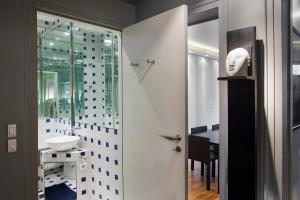 a bathroom with a sink and a glass door at Faubourg Chic in Paris