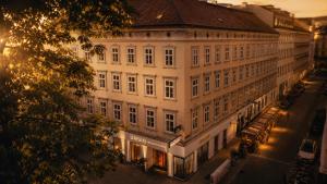 a large white building on a city street at night at Urban Budget Hotel- Unique Boutique Hotel on Best Location in Vienna