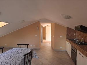 a kitchen and dining room with a table in a room at La mansarda di Iside in Fondi +9 photos