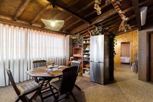 a dining room with a table and a refrigerator at Casas da Aldeia da Graça in Guimarães