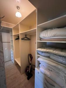 a room with a closet with a bed and towels at Classic Contemporary Apartament in Chişinău