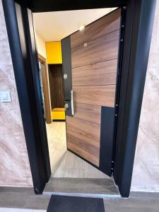a large wooden door in a room at Kokolino in Irig