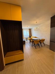 a living room with a tv and a table and chairs at Kokolino in Irig