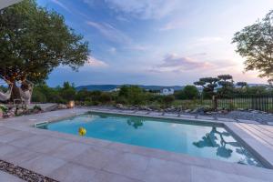 a swimming pool in a yard with a patio at Villa Elementa Krk - Luxury Four Elements Experience in Krk